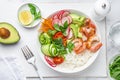 Avocado, prawn, cucumber, tomato, radish, carrot and rice salad bowl. Healthy food