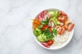 Avocado, prawn, cucumber, tomato, radish, carrot and rice salad bowl. Healthy food