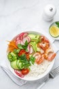 Avocado, prawn, cucumber, tomato, radish, carrot and rice salad bowl. Healthy food