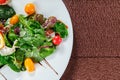 Yellow tomato, cucumber, red cabbage and watermelon radish vegetables salad. healthy raw vegan lunch bowl. Top view Royalty Free Stock Photo