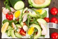 Avocado salad with chicken, rucola and cherry tomatoes in white plate. Royalty Free Stock Photo