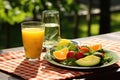 avocado salad served with a glass of fresh orange juice on an outdoor picnic table Royalty Free Stock Photo