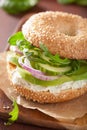 avocado sandwich on bagel with cream cheese onion cucumber arugula