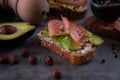 Avocado sandwich close up on grey stone kitchen table with ingredients in the background Royalty Free Stock Photo