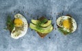 Avocado, sandwiches on whole grain bread with tri-colored tomatoes on rustic baking tray