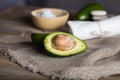 Avocado section on a wooden surface.