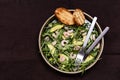 Avocado, Shrimp and Arugula Salad in a plate and toasts grill