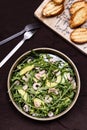 Avocado, Shrimp and Arugula Salad in a plate and toasts grill