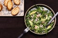 Avocado, Shrimp and Arugula Salad in a plate and toasts grill