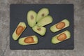 Avocado sliced vegetable on stone black board, top view Royalty Free Stock Photo