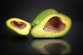 Avocado slices with a black background.