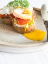 Avocado, smoked salmon and poached toast on rustic plate Healthy breakfast concept. Selective focus. Copy space