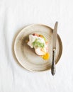 Avocado, smoked salmon and poached toast on rustic plate Healthy breakfast concept. Top view. Copy space