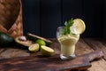 Avocado smoothie and lime in a glass. Food for health and beauty. Super food from vegetables and fruits. Wooden background, free