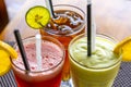 Avocado smoothie, watermelon shake and cold tea in a glass on a wooden table. Tropical drink concept . Top view, closeup Royalty Free Stock Photo