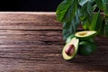 Avocado split in half on old wooden table with free space for your text. Royalty Free Stock Photo