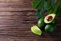 Avocado split in half on old wooden table with free space for your text. Royalty Free Stock Photo