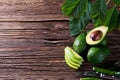 Avocado split in half on old wooden table with free space for your text. Royalty Free Stock Photo