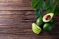 Avocado split in half on old wooden table with free space for your text. Royalty Free Stock Photo