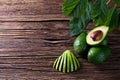 Avocado split in half on old wooden table with free space for your text. Royalty Free Stock Photo