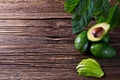 Avocado split in half on old wooden table with free space for your text. Royalty Free Stock Photo