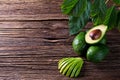 Avocado split in half on old wooden table with free space for your text. Royalty Free Stock Photo