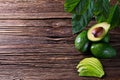 Avocado split in half on old wooden table with free space for your text. Royalty Free Stock Photo