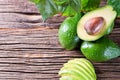 Avocado split in half on old wooden table with free space for your text. Royalty Free Stock Photo