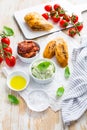 Avocado spread and sun dried tomatoes with olive oil as antipasto and baguette