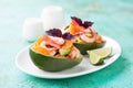 Avocado stuffed with shrimp, apricots or mango and basil. Salad served in avocado peel