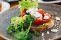 Avocado Toast with Cherry Tomatoes and Feta Cheese. Roast, eating. Royalty Free Stock Photo