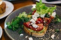 Avocado Toast with Cherry Tomatoes and Feta Cheese. Roast, eating. Royalty Free Stock Photo