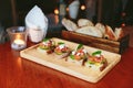 Avocado Toast with Cherry Tomatoes and Feta Cheese, Topping with Rocket leaves. Served with sliced bread in the background Royalty Free Stock Photo