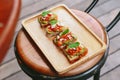 Avocado Toast with Cherry Tomatoes and Feta Cheese, Topping with Rocket leaves. Served on wooden chair Royalty Free Stock Photo