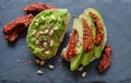 Avocado toast with dried tomatoes, pine nuts and flaxseeds. Close up. top view