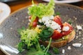 Avocado Toast with Cherry Tomatoes and Feta Cheese. Roast, eating. Royalty Free Stock Photo