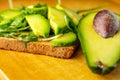 Avocado toast with rucolla on wooden table Royalty Free Stock Photo