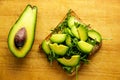 Avocado toast with rucolla on wooden table Royalty Free Stock Photo