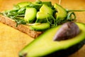 Avocado toast with rucolla on wooden table Royalty Free Stock Photo