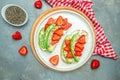 Avocado toast with strawberries, soft cheese and chia seeds on a light background. healthy Breakfast or lunch. Keto diet. Food Royalty Free Stock Photo