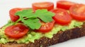 Avocado Toast with Tomatoes and Parsley on a White Plate on a White Background. Royalty Free Stock Photo