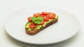 Avocado Toast with Tomatoes and Parsley on a White Plate on a White Background. Royalty Free Stock Photo
