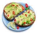 Avocado toasts - bread with avocado slices, pieces of chilli pepper and black sesame isolated on blue plate. Clipping path Royalty Free Stock Photo