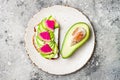 Avocado and watermelon radish toast with chia seeds. Healthy green veggie breakfast sanddwich. Top view, overhead. Royalty Free Stock Photo