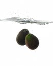 Avocadoes Splashing in water Royalty Free Stock Photo