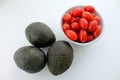 Avocados and cherry tomatoes on a white background isolated