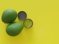 Avocados and Guacamole in a yellow background studio set top view