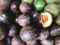 Avocados have vitamin piles and are peeled to see that the ripe fruit is ready to be eaten for sale at the market