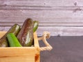 Avocados on a wooden crate with a wooden wall background. Royalty Free Stock Photo