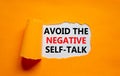Avoid negative self-talk symbol. Concept words Avoid the negative self-talk on white paper on a beautiful orange background.